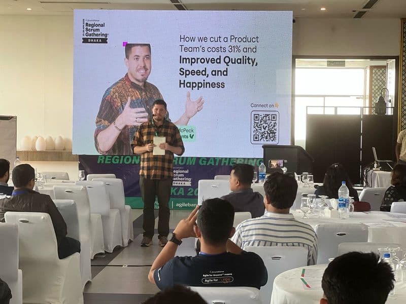 Isaiah McPeak presenting 'How we cut a Product Team's costs 31% and Improved Quality, Speed, and Happiness' at Regional Scrum Gathering in Dhaka, Bangladesh